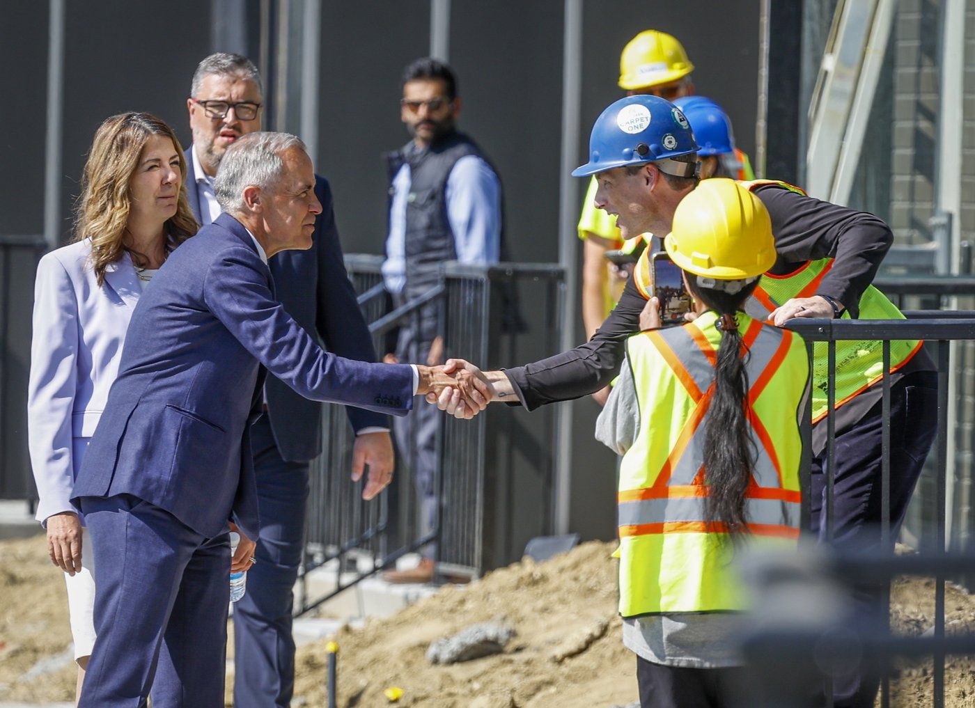 Prime Minister Mark Carney and Alberta Premier Danielle Smith at a housing announcement in Red Deer, Alberta