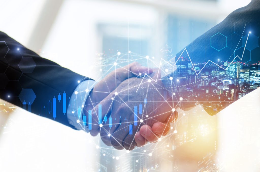 Two professionals shaking hands over a real estate deal
