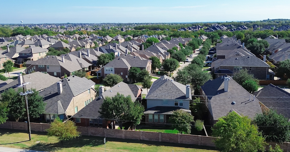 Aerial view of suburban homes representing real estate listing data