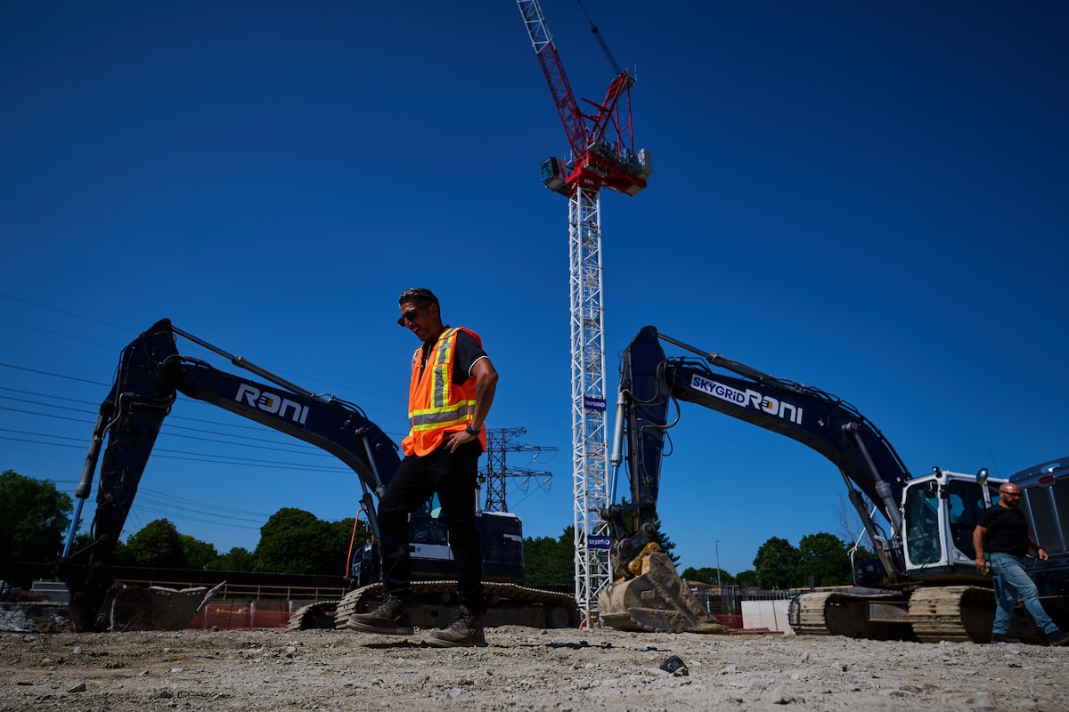 Construction workers moving equipment on a job site