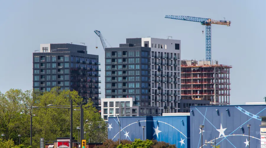 Construction crane above condo towers in a transit-oriented development