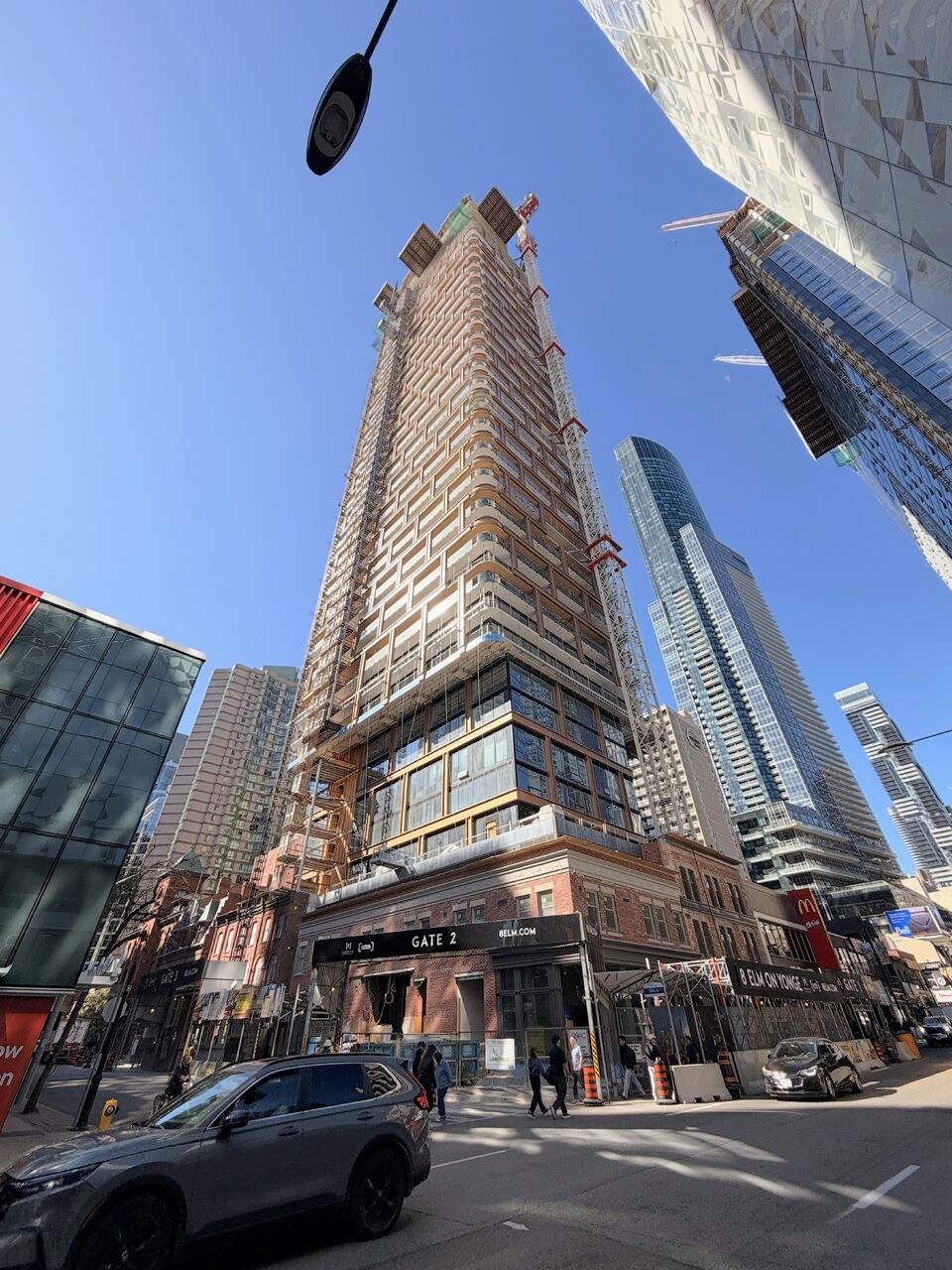 Restored heritage frontage and rooftop terrace with tower rising above at 8 Elm Street, Toronto
